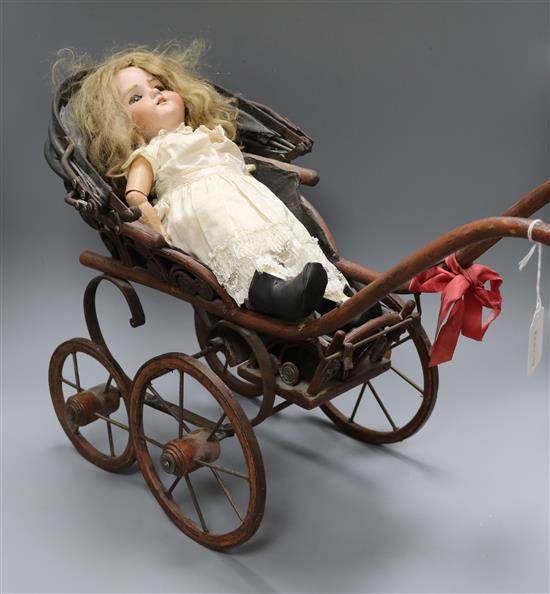 A Victorian dolls pram and a German bisque head doll doll 36cm